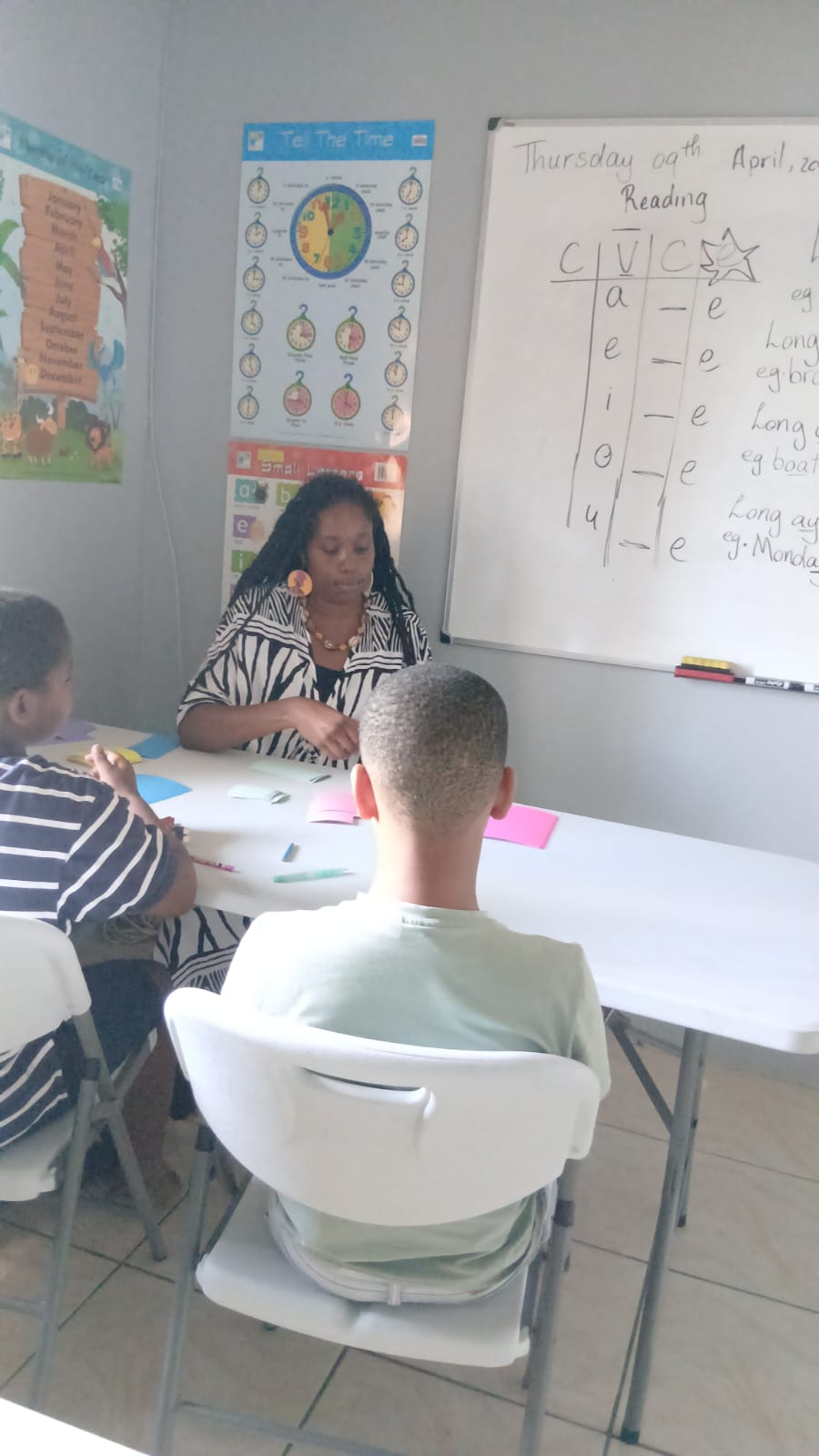 Ms. Dumas leading a small-group CVC reading session at Think-Top Educational Institute